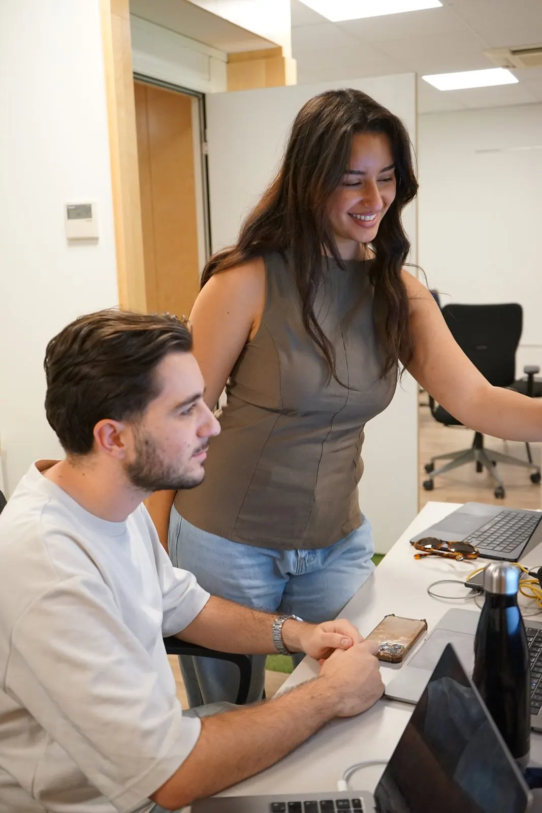 Two collaborators pairing at a computer in the Marseille workshop