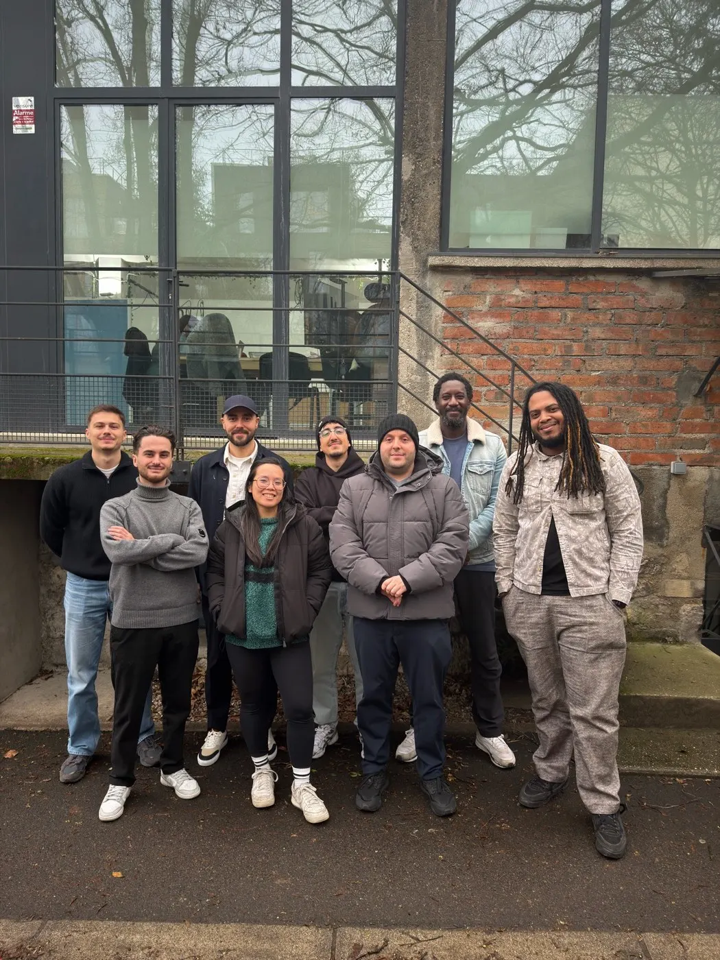 The Paris workshop team gathered in front of a brick building